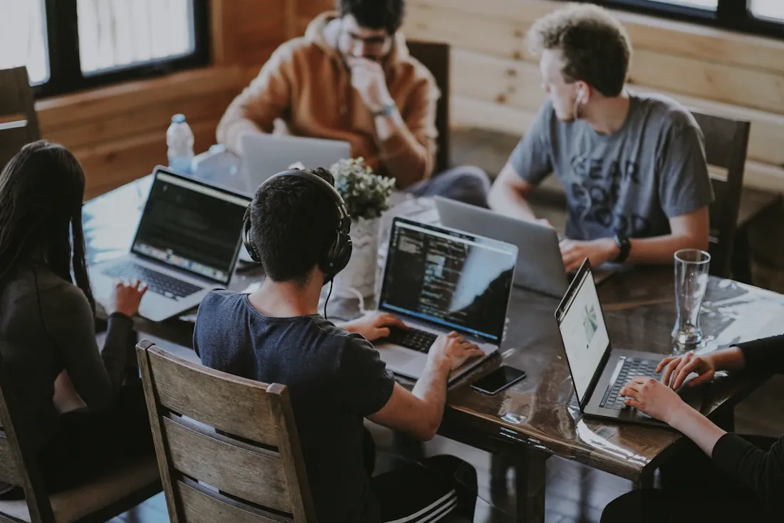 Creative professionals collaborating around a laptop
