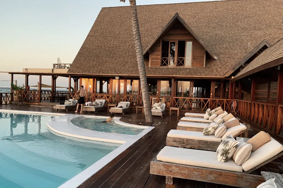 Resort pool surrounded by architecture and palm trees