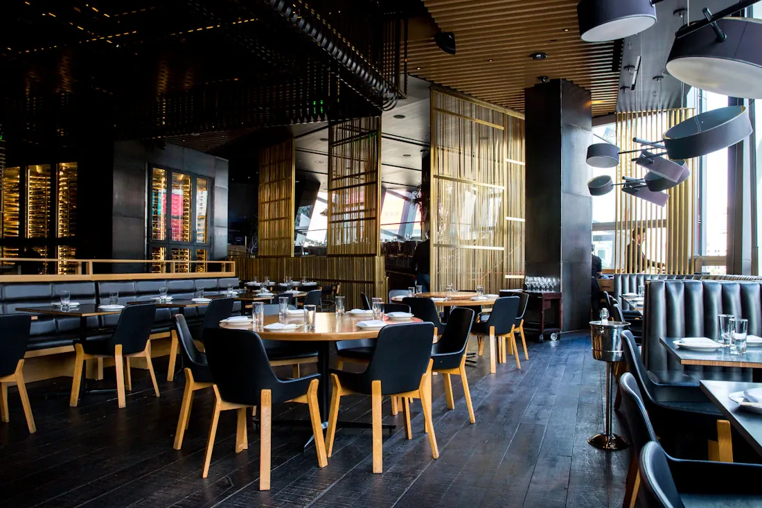 Warm restaurant interior with timber furniture and pendant lighting