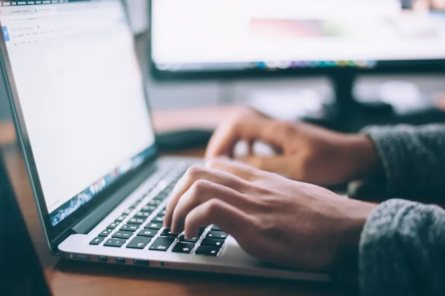 Person typing on a laptop in a professional workspace