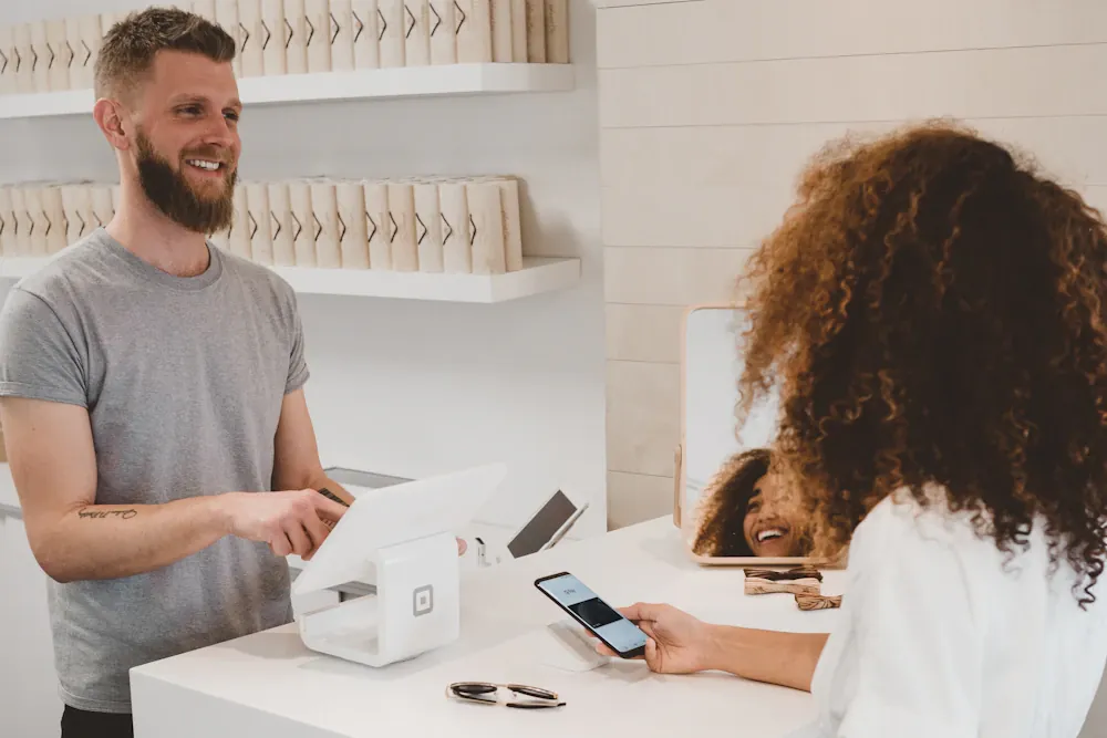 Customer completing a card payment in a shop