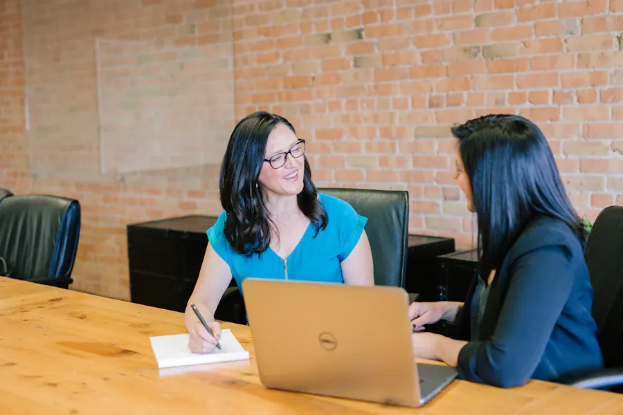 Colleagues discussing work in an office